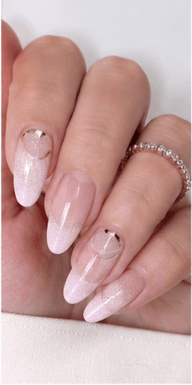 Almond nails are shaped with tapered sides and a softly rounded point, resembling the silhouette of an almond. This shape is loved for its elegant, feminine, and lengthening effect, making the fingers appear slimmer and more refined. Almond nails work best with medium to long nails, either natural or extended, because the tapered form needs enough length to balance the tip. They pair beautifully with French tips, chrome, cat-eye, aura, floral designs, pearls, marble, and bridal styles. Almond is a strong choice for clients who want sophistication, trend appeal, and a flattering hand shape without the sharpness of stiletto nails.
