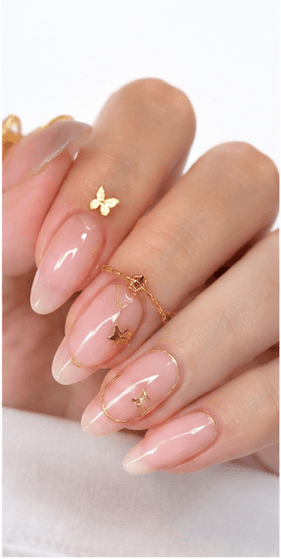 Almond nails are shaped with tapered sides and a softly rounded point, resembling the silhouette of an almond. This shape is loved for its elegant, feminine, and lengthening effect, making the fingers appear slimmer and more refined. Almond nails work best with medium to long nails, either natural or extended, because the tapered form needs enough length to balance the tip. They pair beautifully with French tips, chrome, cat-eye, aura, floral designs, pearls, marble, and bridal styles. Almond is a strong choice for clients who want sophistication, trend appeal, and a flattering hand shape without the sharpness of stiletto nails.
