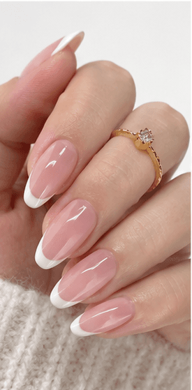 Almond nails are shaped with tapered sides and a softly rounded point, resembling the silhouette of an almond. This shape is loved for its elegant, feminine, and lengthening effect, making the fingers appear slimmer and more refined. Almond nails work best with medium to long nails, either natural or extended, because the tapered form needs enough length to balance the tip. They pair beautifully with French tips, chrome, cat-eye, aura, floral designs, pearls, marble, and bridal styles. Almond is a strong choice for clients who want sophistication, trend appeal, and a flattering hand shape without the sharpness of stiletto nails.