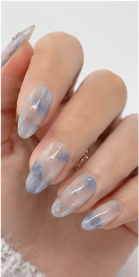 Almond nails are shaped with tapered sides and a softly rounded point, resembling the silhouette of an almond. This shape is loved for its elegant, feminine, and lengthening effect, making the fingers appear slimmer and more refined. Almond nails work best with medium to long nails, either natural or extended, because the tapered form needs enough length to balance the tip. They pair beautifully with French tips, chrome, cat-eye, aura, floral designs, pearls, marble, and bridal styles. Almond is a strong choice for clients who want sophistication, trend appeal, and a flattering hand shape without the sharpness of stiletto nails.