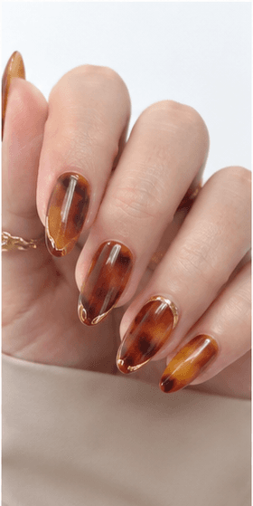 Almond nails are shaped with tapered sides and a softly rounded point, resembling the silhouette of an almond. This shape is loved for its elegant, feminine, and lengthening effect, making the fingers appear slimmer and more refined. Almond nails work best with medium to long nails, either natural or extended, because the tapered form needs enough length to balance the tip. They pair beautifully with French tips, chrome, cat-eye, aura, floral designs, pearls, marble, and bridal styles. Almond is a strong choice for clients who want sophistication, trend appeal, and a flattering hand shape without the sharpness of stiletto nails.