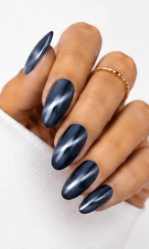 Cat-eye nails use magnetic gel to create a luminous line or velvet-like glow that shifts when the hands move. The effect resembles the reflective depth of a gemstone or a cat’s eye, giving the manicure a mysterious and elegant finish. This style is popular because it looks dimensional without needing complicated hand-painted art. It can be dramatic with dark jewel tones, romantic with pink and champagne shades, or soft and wearable with nude magnetic gels. Cat-eye nails are especially strong for salon photo collections because the light movement makes each angle look slightly different and luxurious.