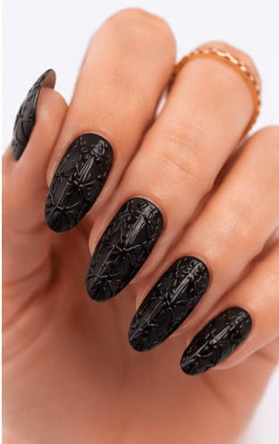 Emboss nails create raised patterns that look pressed, carved, or sculpted into the manicure surface. Unlike large 3D charms, emboss designs are usually more integrated with the nail and often appear as raised flowers, lace, shells, knit textures, monograms, ribbons, or ornamental lines. This style feels refined because the texture can be subtle while still adding depth and craftsmanship. White emboss over nude or milky bases looks bridal and elegant, while metallic or dark emboss can feel vintage, gothic, or fashion-forward. It is useful for luxury nail collections, wedding menus, winter knit designs, and close-up beauty photography.