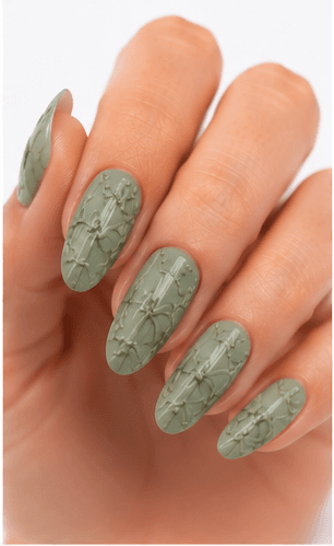 Emboss nails create raised patterns that look pressed, carved, or sculpted into the manicure surface. Unlike large 3D charms, emboss designs are usually more integrated with the nail and often appear as raised flowers, lace, shells, knit textures, monograms, ribbons, or ornamental lines. This style feels refined because the texture can be subtle while still adding depth and craftsmanship. White emboss over nude or milky bases looks bridal and elegant, while metallic or dark emboss can feel vintage, gothic, or fashion-forward. It is useful for luxury nail collections, wedding menus, winter knit designs, and close-up beauty photography.