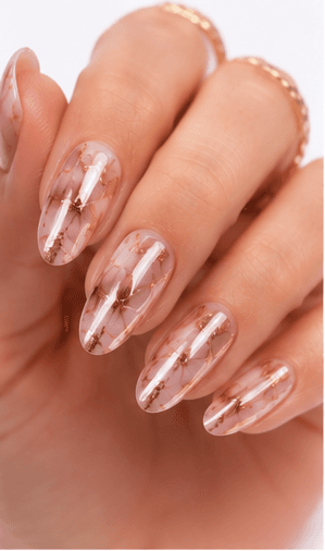 Foil nails use thin metallic or colored foil pieces to add shine, texture, and an irregular luxury effect to the manicure. The foil can be pressed lightly for scattered accents, layered under sheer gel for a soft glow, or placed boldly over dark colors for a dramatic editorial look. This style is popular because it gives every set a handcrafted, premium feeling without requiring complex hand painting. Gold foil feels elegant and bridal, silver foil looks modern, while holographic or colored foil creates a playful fashion mood. It works well for salon galleries, seasonal collections, and clients who want detail with minimal effort.