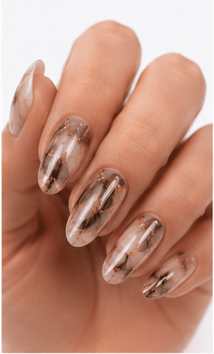 Foil nails use thin metallic or colored foil pieces to add shine, texture, and an irregular luxury effect to the manicure. The foil can be pressed lightly for scattered accents, layered under sheer gel for a soft glow, or placed boldly over dark colors for a dramatic editorial look. This style is popular because it gives every set a handcrafted, premium feeling without requiring complex hand painting. Gold foil feels elegant and bridal, silver foil looks modern, while holographic or colored foil creates a playful fashion mood. It works well for salon galleries, seasonal collections, and clients who want detail with minimal effort.