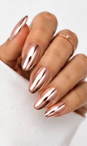 Mirror nails are known for their polished metallic reflection, creating a sleek, futuristic look that instantly catches the light. This style is often made with chrome powder or reflective gel layered over a smooth base color, giving the nails a glassy, high-shine finish. It works beautifully for minimalist fashion, luxury beauty shoots, party looks, and editorial nail collections. Depending on the base shade, mirror nails can feel cool and modern, glamorous and bold, or soft and elegant. They are especially popular among clients who want a statement manicure without heavy patterns or complicated art.