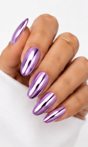 Mirror nails are known for their polished metallic reflection, creating a sleek, futuristic look that instantly catches the light. This style is often made with chrome powder or reflective gel layered over a smooth base color, giving the nails a glassy, high-shine finish. It works beautifully for minimalist fashion, luxury beauty shoots, party looks, and editorial nail collections. Depending on the base shade, mirror nails can feel cool and modern, glamorous and bold, or soft and elegant. They are especially popular among clients who want a statement manicure without heavy patterns or complicated art.