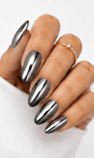Mirror nails are known for their polished metallic reflection, creating a sleek, futuristic look that instantly catches the light. This style is often made with chrome powder or reflective gel layered over a smooth base color, giving the nails a glassy, high-shine finish. It works beautifully for minimalist fashion, luxury beauty shoots, party looks, and editorial nail collections. Depending on the base shade, mirror nails can feel cool and modern, glamorous and bold, or soft and elegant. They are especially popular among clients who want a statement manicure without heavy patterns or complicated art.