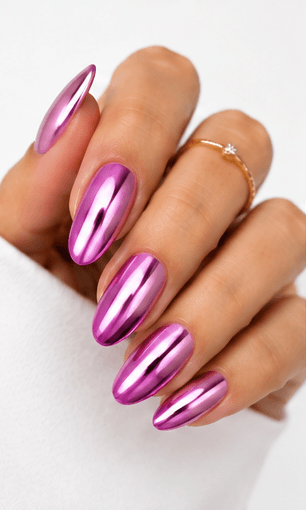 Mirror nails are known for their polished metallic reflection, creating a sleek, futuristic look that instantly catches the light. This style is often made with chrome powder or reflective gel layered over a smooth base color, giving the nails a glassy, high-shine finish. It works beautifully for minimalist fashion, luxury beauty shoots, party looks, and editorial nail collections. Depending on the base shade, mirror nails can feel cool and modern, glamorous and bold, or soft and elegant. They are especially popular among clients who want a statement manicure without heavy patterns or complicated art.