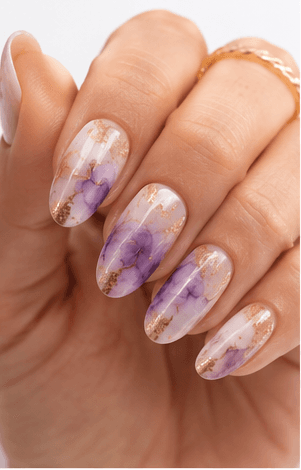 Watercolor nails are inspired by the soft transparency and flowing pigments of watercolor painting. This style uses diluted gel colors, sheer washes, and blended edges to create an artistic, airy look on the nails. It can feel romantic with florals, modern with abstract color clouds, or fresh with pastel gradients. Watercolor nails are especially useful for clients who want a delicate design that still feels creative and personal. Because the effect is light and layered, it photographs beautifully for beauty editorials, spring collections, bridal nail sets, and soft lifestyle content.