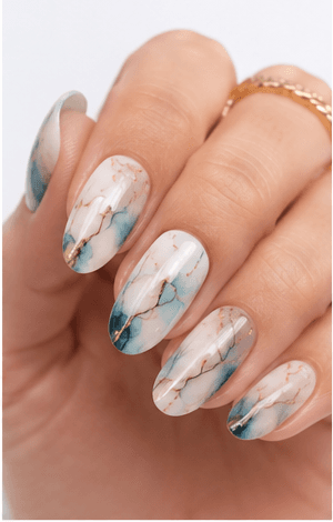 Watercolor nails are inspired by the soft transparency and flowing pigments of watercolor painting. This style uses diluted gel colors, sheer washes, and blended edges to create an artistic, airy look on the nails. It can feel romantic with florals, modern with abstract color clouds, or fresh with pastel gradients. Watercolor nails are especially useful for clients who want a delicate design that still feels creative and personal. Because the effect is light and layered, it photographs beautifully for beauty editorials, spring collections, bridal nail sets, and soft lifestyle content.