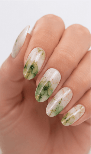 Watercolor nails are inspired by the soft transparency and flowing pigments of watercolor painting. This style uses diluted gel colors, sheer washes, and blended edges to create an artistic, airy look on the nails. It can feel romantic with florals, modern with abstract color clouds, or fresh with pastel gradients. Watercolor nails are especially useful for clients who want a delicate design that still feels creative and personal. Because the effect is light and layered, it photographs beautifully for beauty editorials, spring collections, bridal nail sets, and soft lifestyle content.